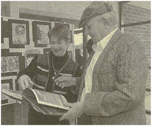 TURNING PAGES: Author Tony Hillerman looks through a book with Helenmarie Zachritz of Espanola at Jemez Springs High School. Paul Bearce/Albuquerque Journal 