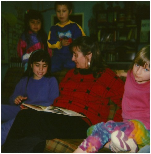 Alice Rodgers, Volunteer, reads to children in the program. 