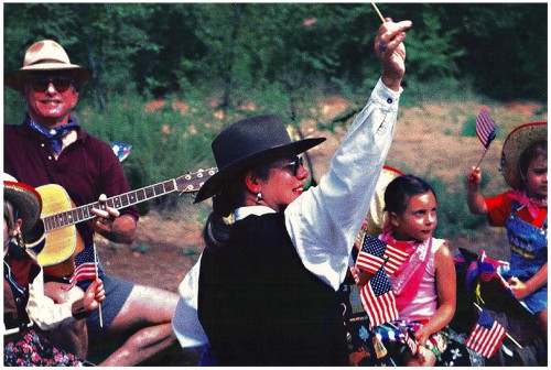 Judith Isaacs, Library Director, waves from the Library float in the 1998 Fourth of July parade.