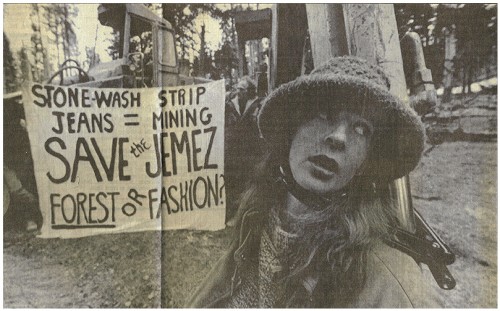Stella Reed of Santa Fe waits for law enforcement officials to arrive after locking herself to a backhoe with a heavy-duty bicycle lock. Photo by Murrae Haynes/Albuquerque Journal