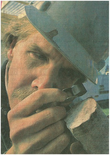 Geologist Jeffery Hulen examines a rock core for mineralization, rock type and other features immediately after it has been raised from a depth of about 4,800 feet. Richard Pipes/Albuquerque Journal